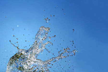 Water splash on blue background close up shootの写真素材