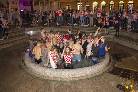 ZAGREB, CROATIA - JULY 11 Croatian football fans after the match of Croatia vs England 2018 FIFA WORLD CUP RUSSIA in the fountains of ManduÅ¡evac on Ban Josip JelaÄiÄ square on July 11, 2018 in Zagreb, Croatiaのeditorial素材