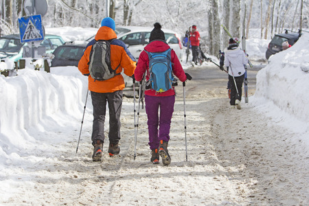 Young couple hiking outside on the snow in winter mountainsの写真素材