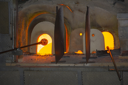 Manufacturing glass in a traditional oven, in glass factory in Murano, Venice, Italyの写真素材