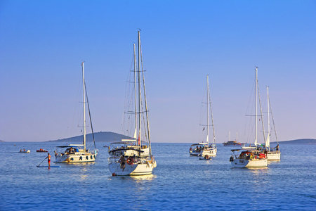 Anchored sailing boats in the bay on island Murter, Croatiaの写真素材