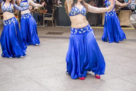 Four Women dancing Belly oriental dance on the streetの写真素材