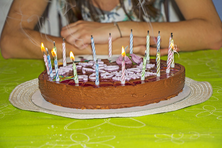 Young girl is to blow out candles on her birthday cakeの写真素材