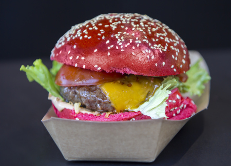 Red burger sprinkled with sesame seeds on a street marketの写真素材