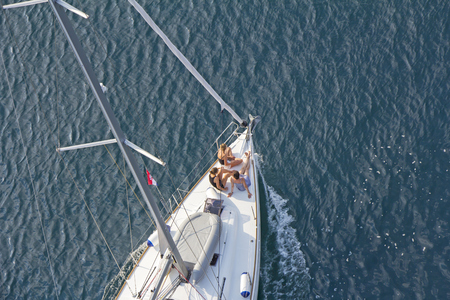 Three young Girls at bow of yachtの写真素材