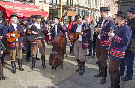ZAGREB, CROATIA - FEBRUARY 15, 2019: Croatian musicians in traditional Slavonian costumes, play on Ban Jelacic Square in Zagreb, Croatia.のeditorial素材