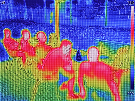 Infrared thermovision image showing when People sit at the table in the summerの写真素材