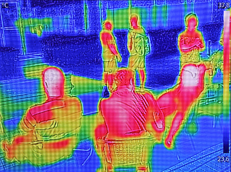 Infrared thermovision image showing when People sit at the table in the summerの写真素材