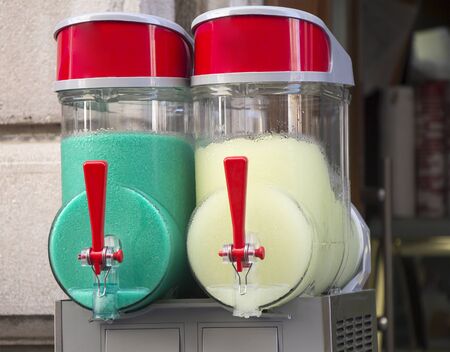 Two flavors of grenadine ice for sale on the streetの写真素材