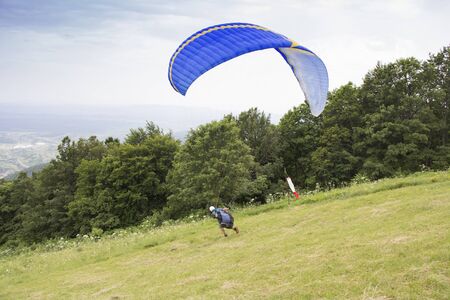 Paraglider taking off from the edge of the mountain, in Japetic Croatiaの写真素材