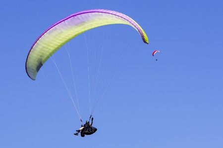 Paragliding in the blue sky as background extreme sportの写真素材
