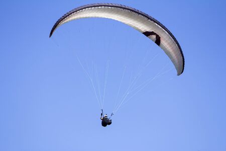 Paragliding in the blue sky as background extreme sportの写真素材
