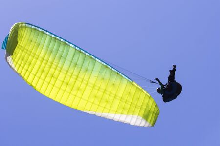 Paragliding in the blue sky as background extreme sportの写真素材