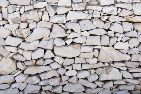 Closeup of dry stone wall as backgroundの写真素材