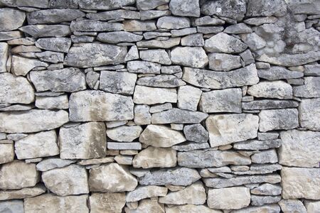 Closeup of dry stone wall as backgroundの写真素材
