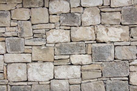 Closeup of dry stone wall as backgroundの写真素材