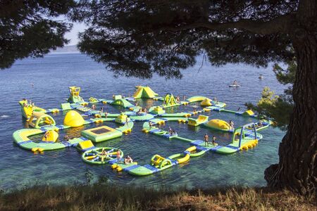 BOL, CROATIA - AUGUST 06, 2019: Water fun park on a Zlatni Rat beach in Bol on the island of Bracのeditorial素材