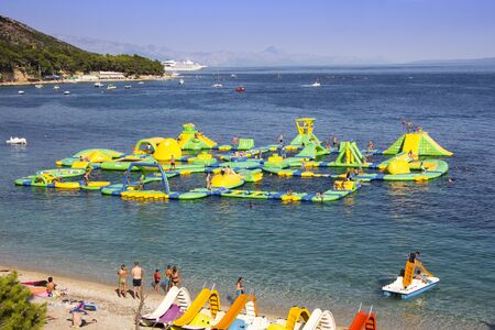 BOL, CROATIA - AUGUST 06, 2019: Water fun park on a Zlatni Rat beach in Bol on the island of Bracのeditorial素材