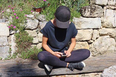 Young girl watching smart mobile phonの写真素材