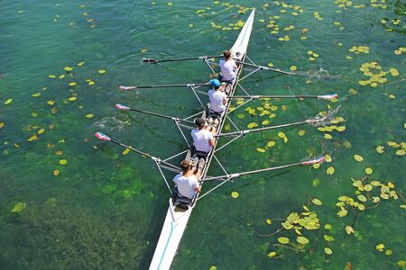 Men's quadruple rowing team on green water, top viewの写真素材