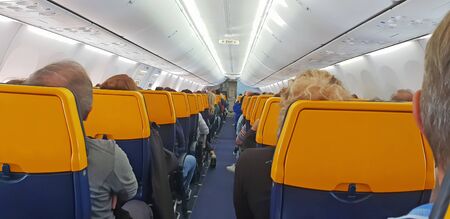 People are sitting in an airplane cabin during flight
の写真素材