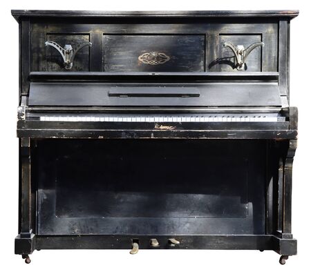 Old wooden black vintage piano isolated on white backgroundの写真素材
