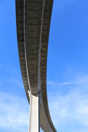 View of concrete road curve of viaduct whit blue sky backgroundの写真素材