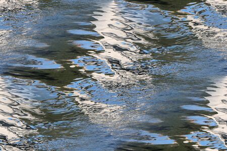 Reflection of the coast on the surface of the water as seamless backgroundの写真素材
