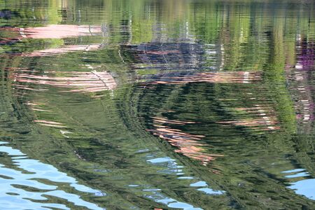 Reflection of the coast on the surface of the water as backgroundの写真素材