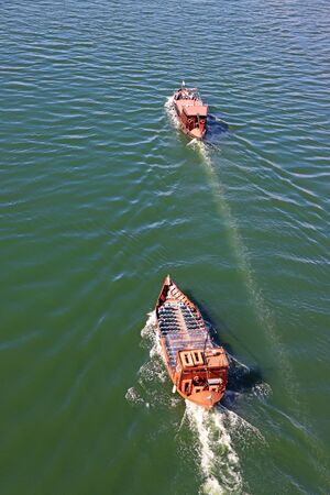 Tourist boat moving on The Duoro river in Porto view from above の写真素材