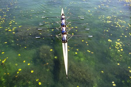 Women's quadruple rowing team on turquoise green lake

の写真素材