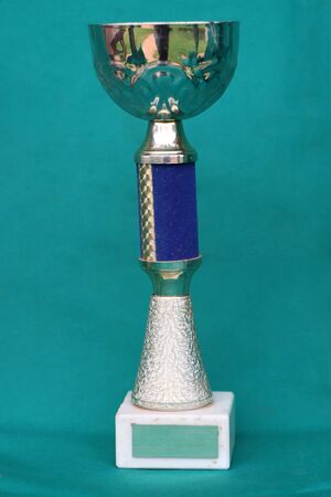 Champion cup with reflection on green background. の写真素材