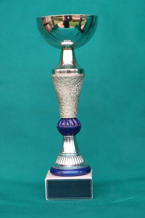 Champion cup with reflection on green background. の写真素材