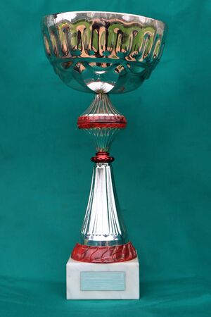 Champion cup with reflection on green background. の写真素材