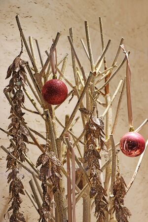 Two red christmas balls on a golden twigs as decorationの写真素材