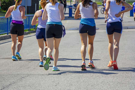 Group Young girls friends running on the city streetの写真素材