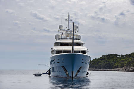 Blue luxury motor yacht, anchored in the calm seaの写真素材