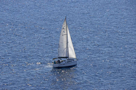Small Sailing boat yacht in the open blue Seaの写真素材
