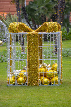Christmas gift boxes with ball in a city parkの写真素材