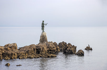 Sculpture of the woman Mermaid with the sea at Opatija, Croatiaの写真素材