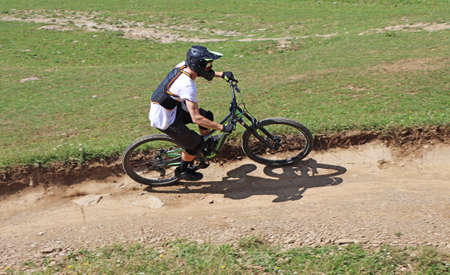 Man on mountain bike rides mountain trail.の写真素材