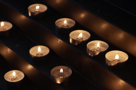 Many burning candles in the church