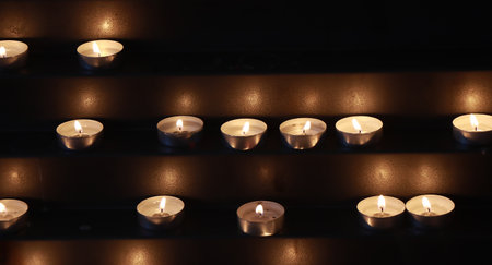Many burning candles in the churchの写真素材