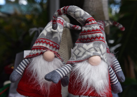 Two read, white and grey Christmas Gnomes with Norwegian folk patterns which look like Trolls in...