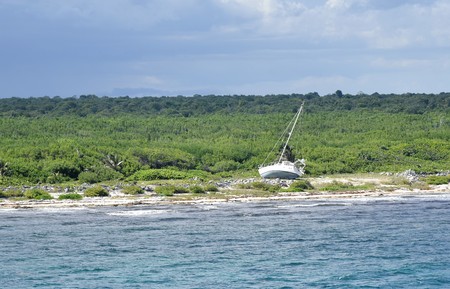 Abandoned Sail Boat on Mexican Costa Maya depicts the lost dreams, goals that are given upの写真素材