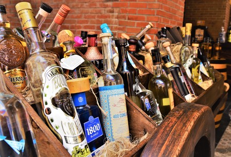 September 2018, Costa Maya - Famous Mexican Tequilla Brands are displayed on wooden barrel and ropesのeditorial素材