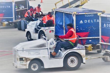 January 2020, Atlanta Airport, GA - Hustle and bustle loading up suitcases to airplanesのeditorial素材