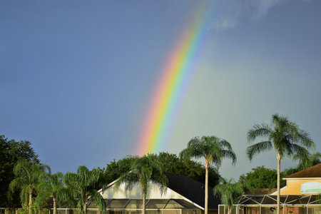 Rainbow over suburban homes in residential neighborhood USAの写真素材