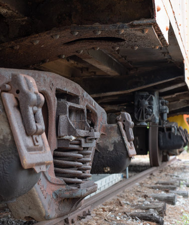 Metal wheels of a train. Lower undercarriage. The carriage stands on the rails. Abandoned rusty locomotive. The chassis of the train.の写真素材