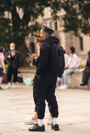 London / UK - 06/27/2020: LGBTQ protester in medical masks decorated with flowers At Black Lives...